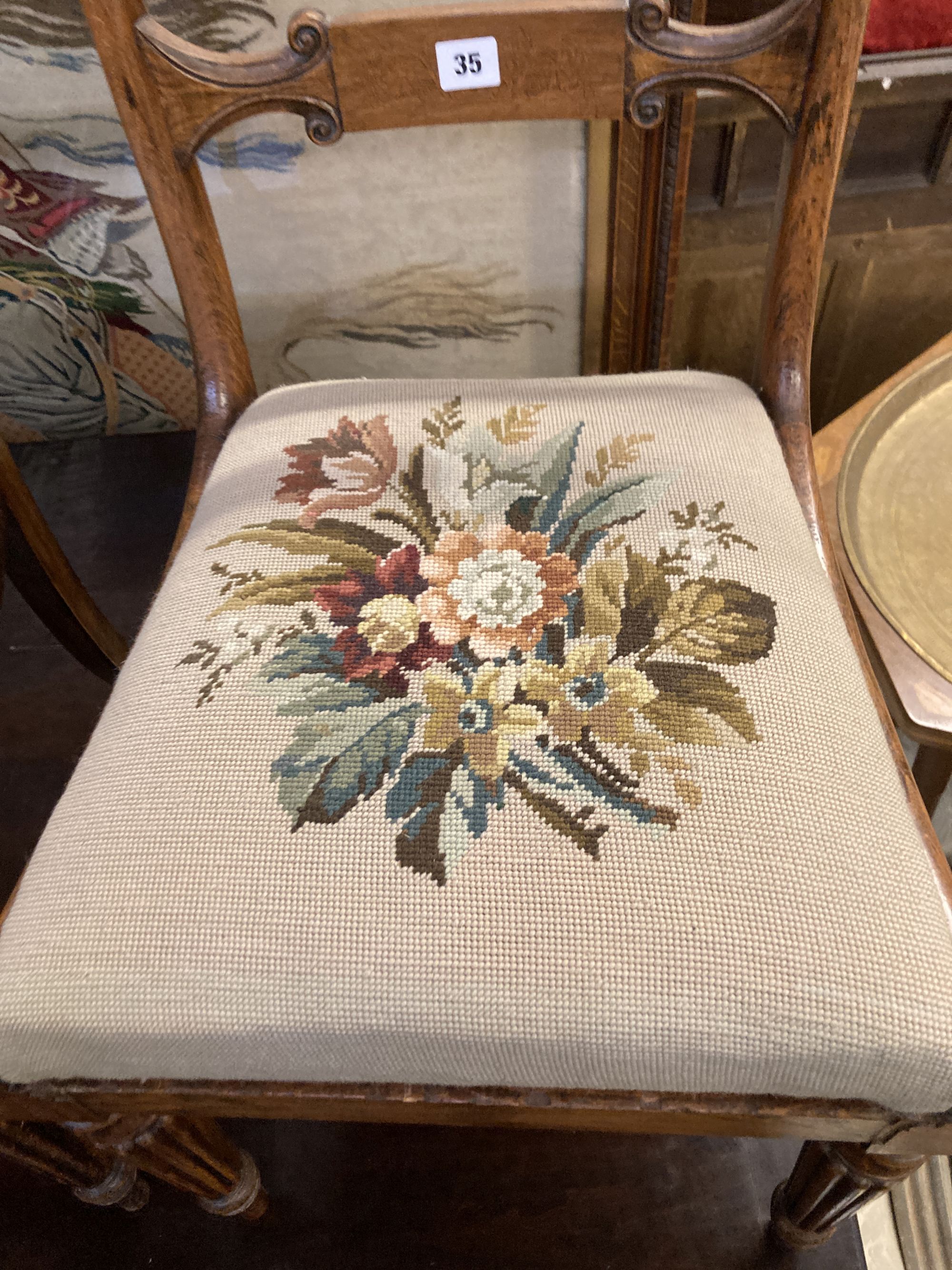 A pair of William IV simulated rosewood dining chairs, with curved marquetry inlaid crest rails and spars, over tapestry drop in seats